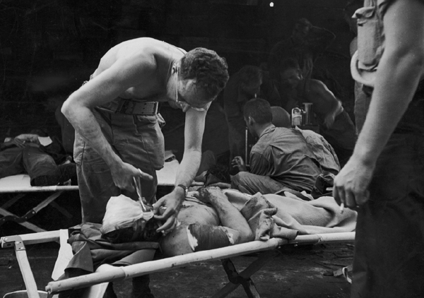 This photo of Bunkin, attending to a wounded GI, appeared in Life magazine and gave his family a clearer picture of his experiences in the Pacific.