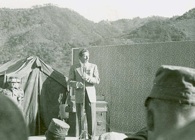 Actor Danny Kaye entertaing troops in Korea, 1952. Today, a USO2GO kit can provide base camps with everything from toothpaste to console gaming. Click to enlarge.