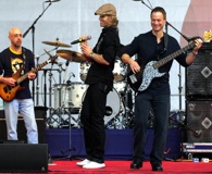 Academy Award-nominated actor Gary Sinise (right) and his LT Dan Band entertain service personnel and their families around the world. Click to enlarge.