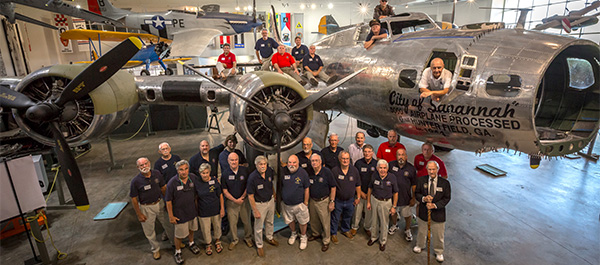 Volunteers pose with 'City of Savannah' as it nears completion. Gulf Stream Aerospace