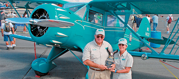 Dave and Jeanne Allen with their Waco YKC, which won the Neil A. Armstrong Trophy.