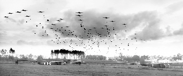 U.S. Army Air Forces C-47s disperse paratroopers onto fields littered with CG-4 assault gliders in what was the largest airborne operation thus far in World War II. (U.S. Army/National Archives)