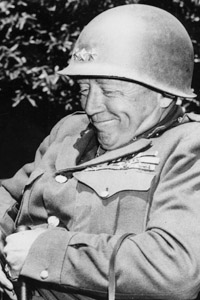 Patton has a good laugh in an undated photo from World War II. (National Archives)
