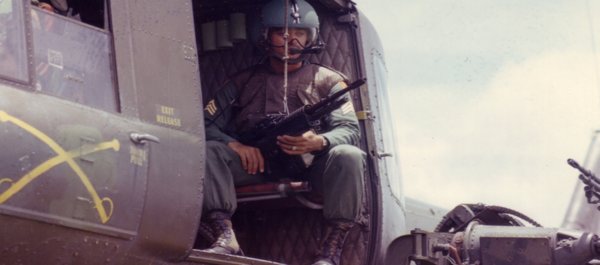 Huey door gunner of the 179th Aviation Company in support of the 173rd Airborne Brigade on Sept. 12, 1965. (National Archives)