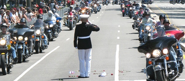 Tim Chambers holds his salute for up to four hours as bikes parade past him. (Photo Christopher Kamsler)