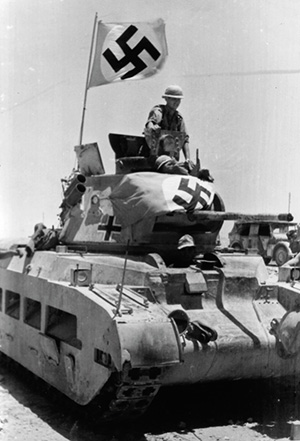 Germans man a captured British Matilda II tank in North Afrika. Swastika flags identify it to aircraft. (National Archives)