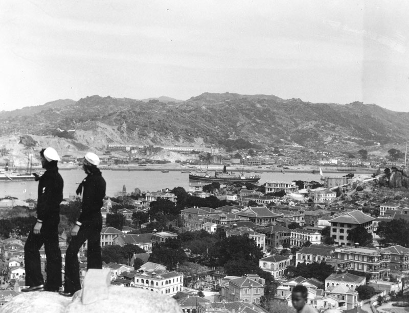 Sailors on a liberty party from the USS Houston take in the view from a huge rock overlooking the city of Kulangsu, on the southeastern coast of China. (National Archives)