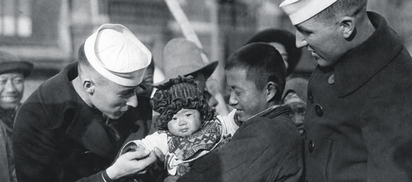 Sailors play with a baby  on a street in Shanghai, a major Yangtze port, in 1930. The exotic Yangtze Patrol Force was one of  the navy’s most sought-after postings. (U.S. Navy/National Archives)