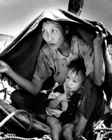 After the U.S. withdrew from Vietnam in 1975, thousands fled the communist regime. Refugees who tried to escape by sea, often in unsound craft, came to be called boat people. (Eddie Adams/Associated Press)