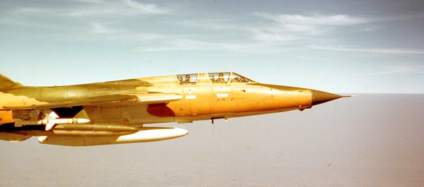 An F-105F "Thud," armed with a Shrike missile, escorts a strike package into North Vietnam in February 1969. (Photo Courtesy Warren Thompson)