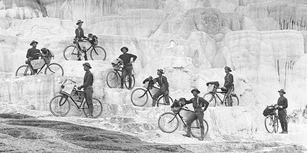 During their 1896 excursion from Fort Missoula, Mont., to Yellowstone National Park, riders of the 25th Infantry Bicycle Corps, led by 2nd Lt. James A. Moss, at top, pose on Minerva Terrace at Mammoth Hot Springs. (World History Group Archive)