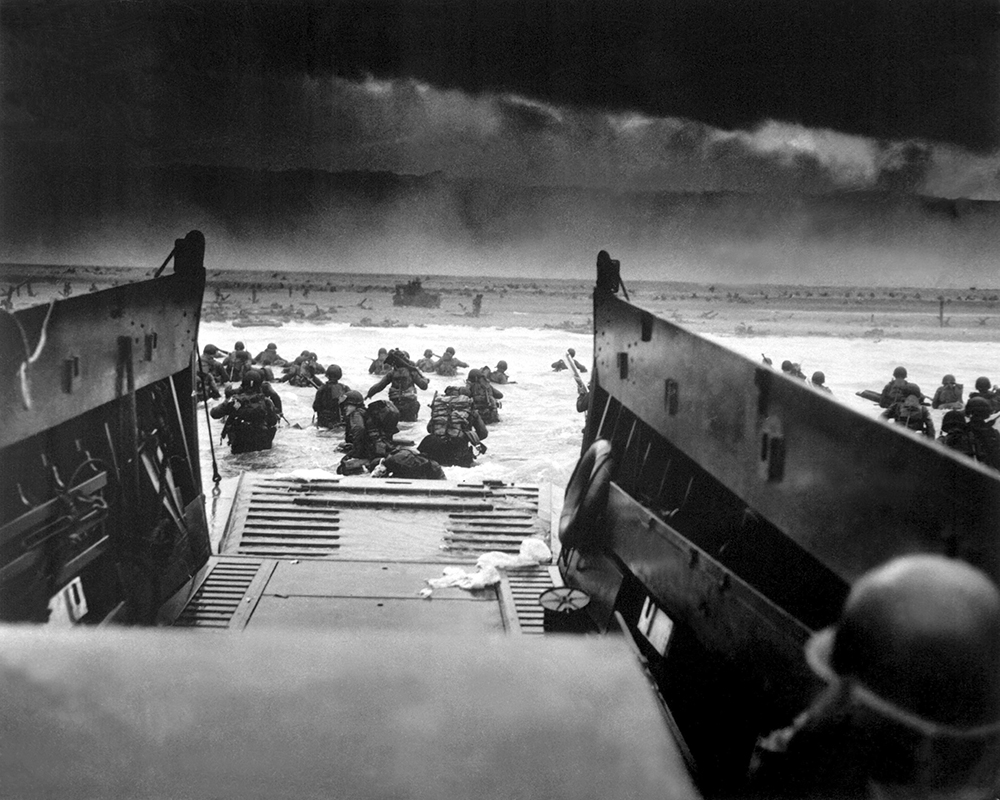 At 0630 hours on June 6, troops of 2nd Battalion, 16th Regiment, 1st Infantry Division exit their landing craft and head for shore under heavy fire on the Easy Red sector of Omaha Beach. Omaha saw the most critical delay of the five Allied beachheads, as well as the most grievous casualties. By the end of the day the 1st Division had suffered 186 dead, 358 missing in action and 620 wounded. The adjacent 29th Infantry Division’s casutalties totaled 341 casualties, mostly from Company A, 116th Infantry, which suffered 96 percent casualties in the first ten minutes. (National Archives)