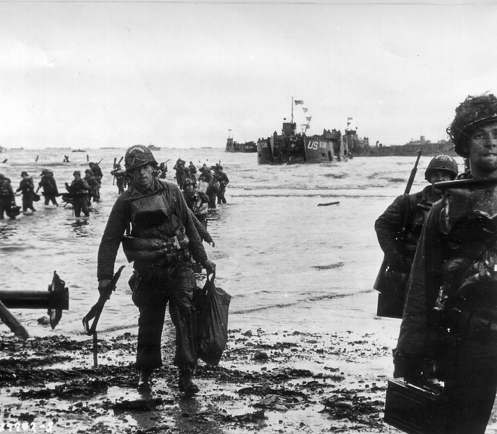 A landing party helps survivors of a landing craft sunk by German shelling to come ashore at Utah, the westernmost of the Normandy beachheads and the nearest to the vitally needed port of Cherbourg. Resistance at Utah and the American casualties suffered there proved to be the lightest, about 200, partially because paratroops of the 82nd and 101st Airborne divisions, who had already landed further inland, were occupying much of the Germans’ attention, and because most of the 4th Infantry Division’s landing craft, driven off course by wind and smoke, landed some 1,800 meters south of the intended location—apparently throwing off the Germans as much as its own officers. (National Archives)