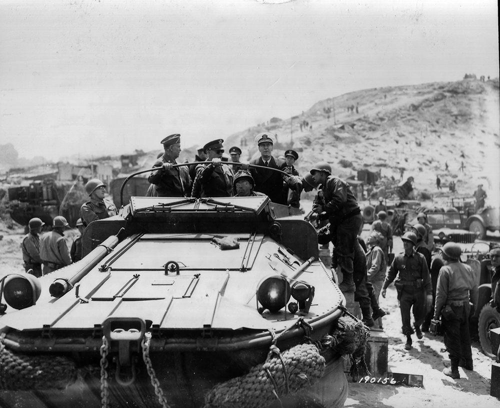 From left, Gen. George C. Marshall, Gen. Dwight D. Eisenhower and Adm. Ernest J. King stop their DUKW at Vierville-sur-Mer on Omaha to question officers of a combat unit on Allied progress during a tour of the Allied beachheads on June 12. (National Archives)