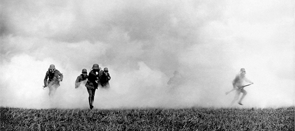 Charging through a toxic cloud, masked German soldiers stage a gas attack on British lines in Flanders. (AKG-Images)