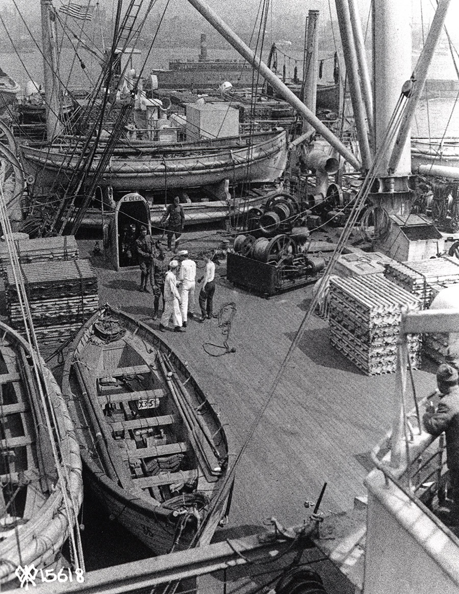 Leviathan’s after deck, already strewn with ventilators, hatch covers and winches, also accommodates lifeboats, cardboard-like floatation devices, cargo-handling equipment and boxes of various supplies. (U.S. Army via Stephen Harding)