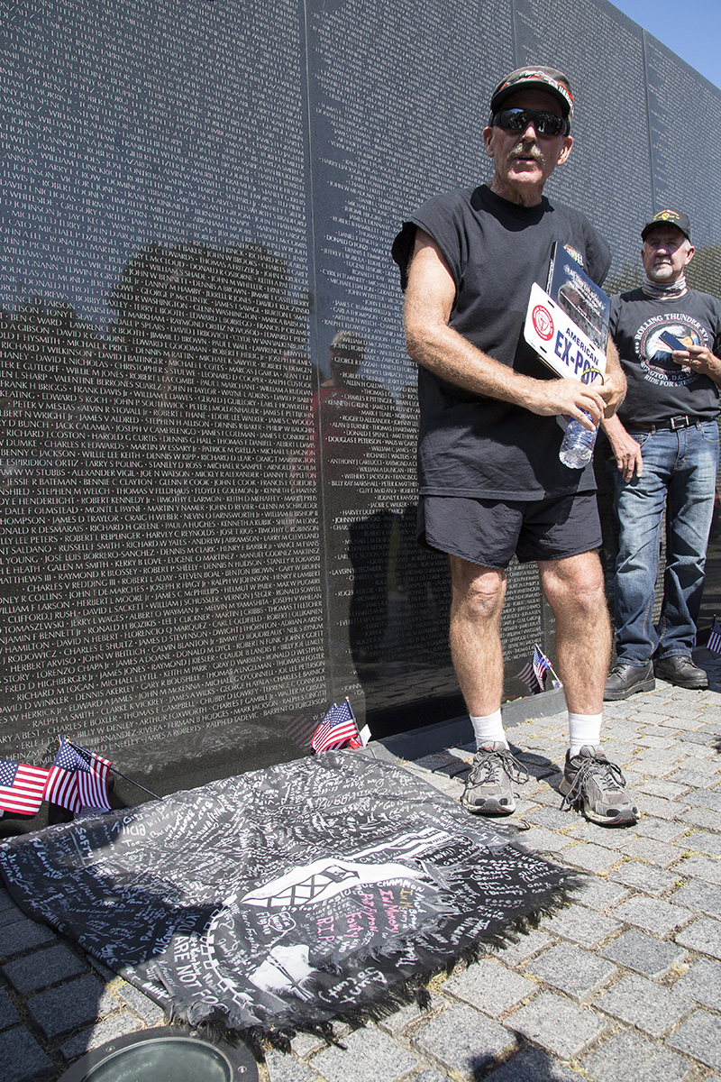 Bowen took one of the POW/MIA flags he had run with to The Wall, tattered and worn and signed by the people from his hometown in Flushing, Mich.