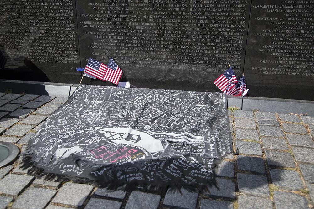 Tattered from its many miles on the run with Bowen, a POW flag, signed by people from Bowen's hometown, was left at The Wall, as a remembrance of their support when Bowen finished the run.