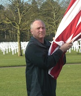 Tim Nosal, ABMC's Director of Public Affairs, raising the flag at the Normandy American Cemetery, 2012.